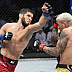 Islam Makhachev def. Charles Oliveira R2 3:16 via Submission (Arm-Triangle Choke)